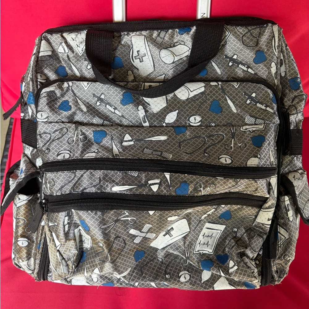 Nurse Mates Black and Blue Medical Pattern large tote with pull up handle, rolls
